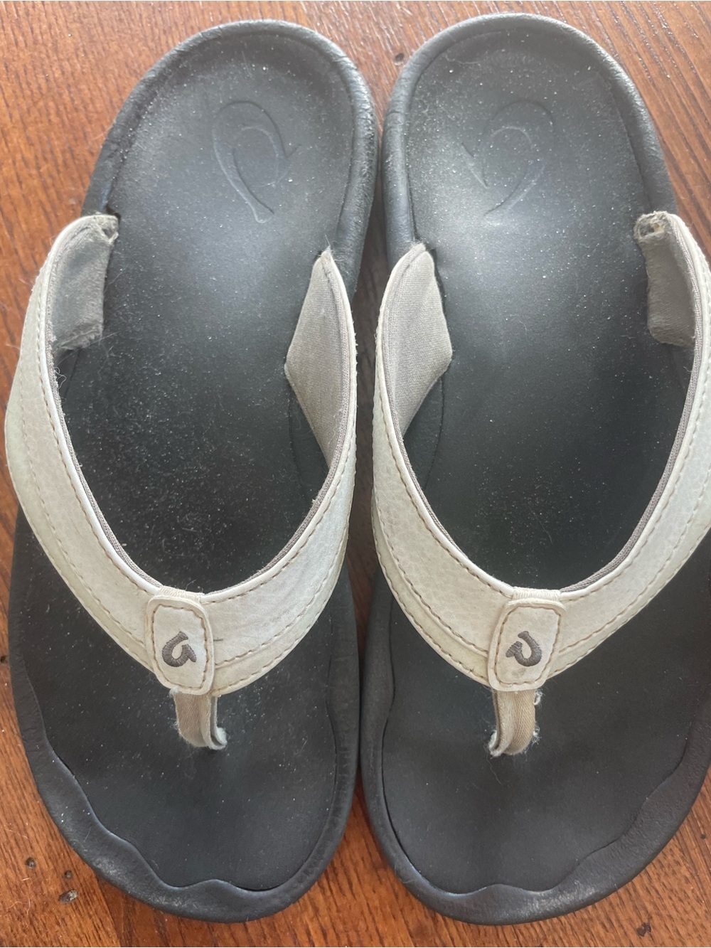 OluKai Black Footbed Flip Flops with Beige Straps